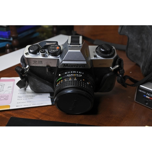 102 - A cased Mamiya camera along with paperwork.