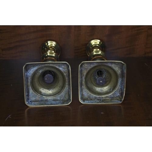 152 - A pair of decorative brass candlesticks