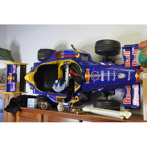 201 - A battery powered Red Bull child's racing car with helmet. (untested)