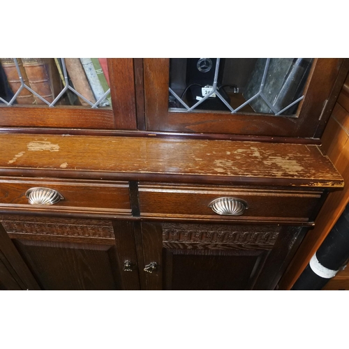 219 - A display cabinet, ideal for upcycling, with lead glass doors and carved detail.