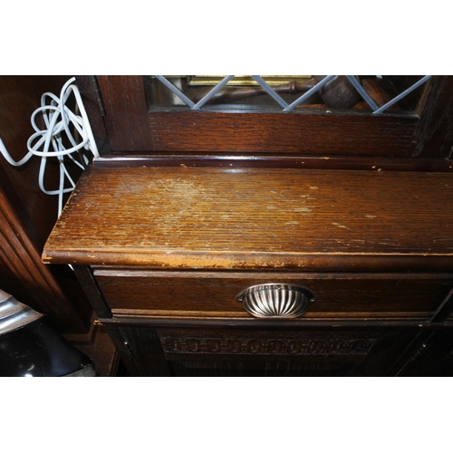 219 - A display cabinet, ideal for upcycling, with lead glass doors and carved detail.