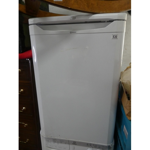 530 - An Indesit under counter fridge.