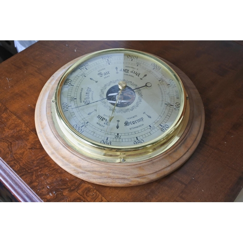 65 - A circular barometer.