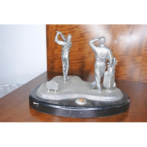 86 - A cast metal golfing statue.