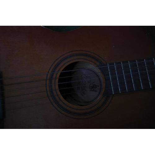 93 - An acoustic guitar.