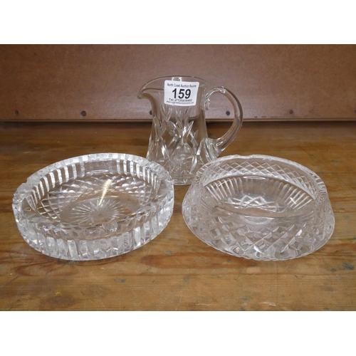 159 - Two large crystal ashtrays and a crystal jug.