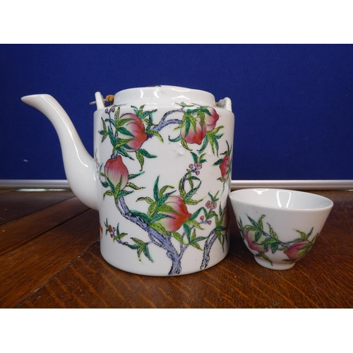 104 - An antique Chinese/ Oriental hand painted tea pot with matching tea bowl.