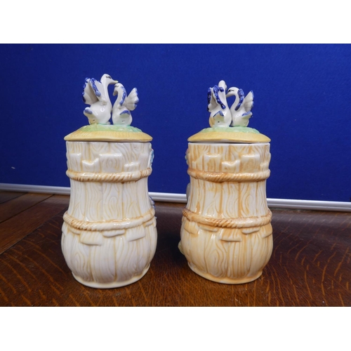 63 - A pair of ceramic lidded jars.