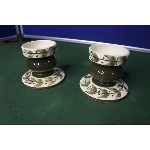 642 - A pair of Jersey Pottery candlesticks.