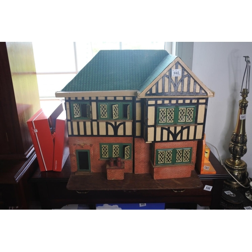 648 - A large wooden dolls house with assortment of furniture.