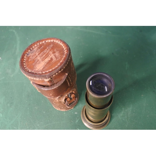 659 - An antique field microscope in leather case.