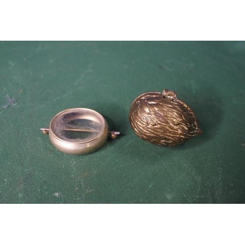 669 - An antique brass novelty Walnut shaped snuff box & mourning brooch (empty).