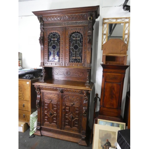 678 - A stunning antique Gothic style cabinet with heavily carved detail & stained glass doors.