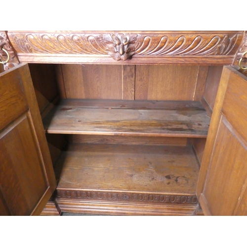 678 - A stunning antique Gothic style cabinet with heavily carved detail & stained glass doors.