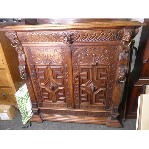 678 - A stunning antique Gothic style cabinet with heavily carved detail & stained glass doors.