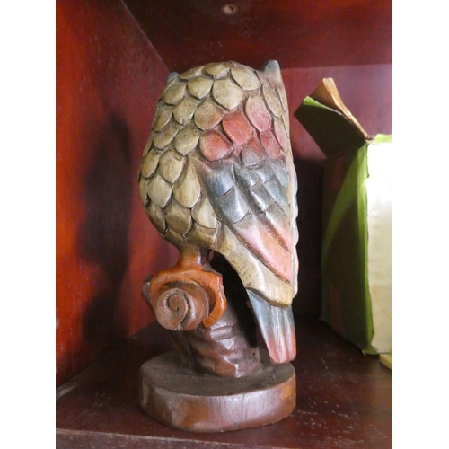 689 - A carved wooden owl.