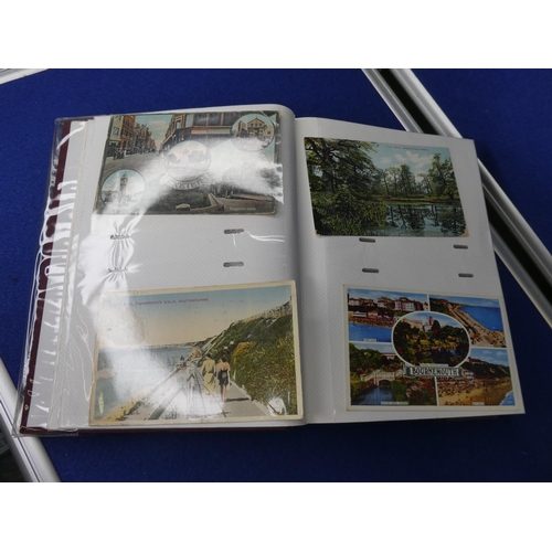 107 - A postcard album with contents.