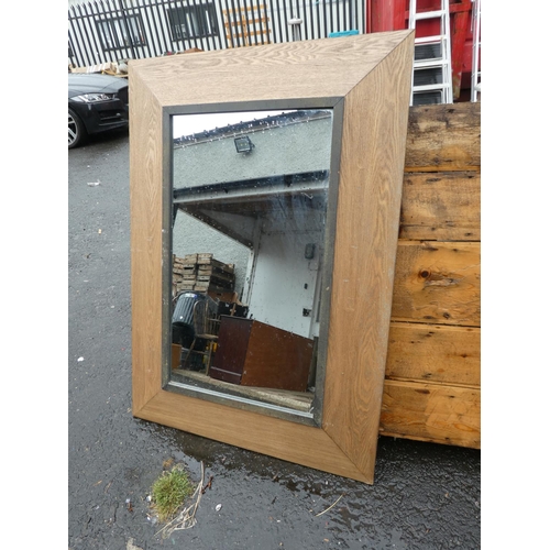 112 - A large modern wood framed mirror.