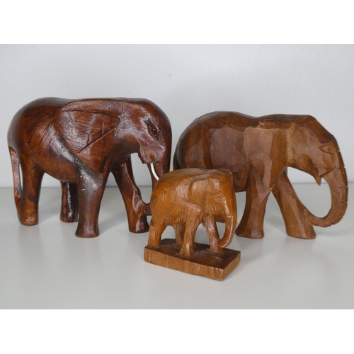 116 - A collection of 3 hand carved wooden elephants.