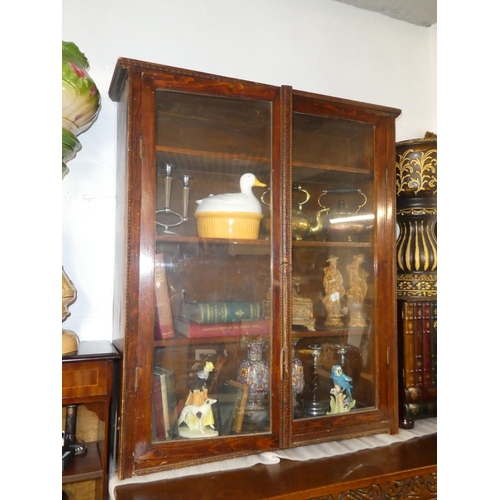 136 - An antique oak bookcase with glazed doors.