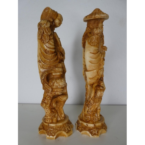 141 - A pair of decorative carved figures.