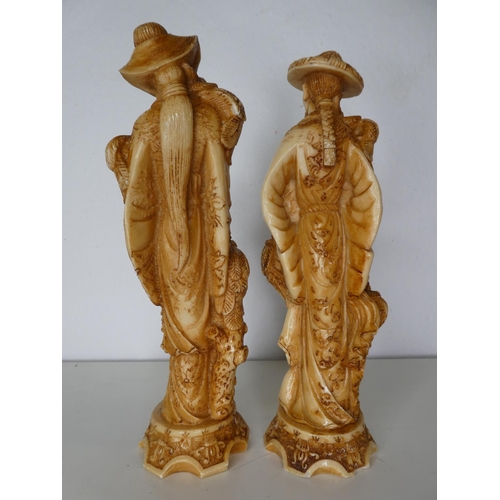 141 - A pair of decorative carved figures.