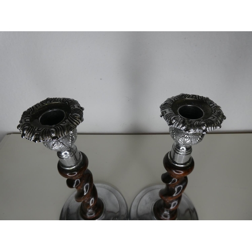 150 - A pair of decorative wood & metal candlesticks.