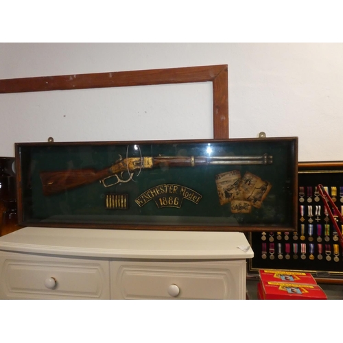 195 - A cased model Winchester Rifle display.