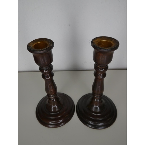 199 - A pair of wooden candlesticks.