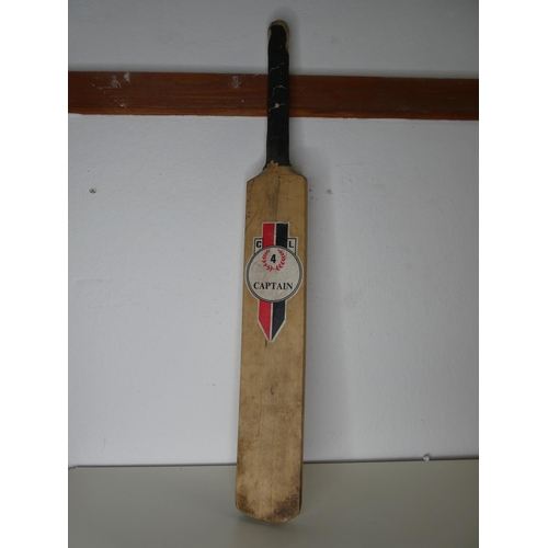 205 - A wooden cricket bat.