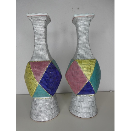 219 - A pair of unusual large ceramic geometrical vases, each signed to base.