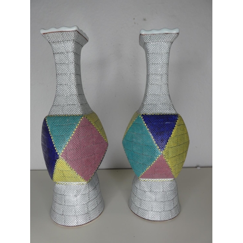 219 - A pair of unusual large ceramic geometrical vases, each signed to base.