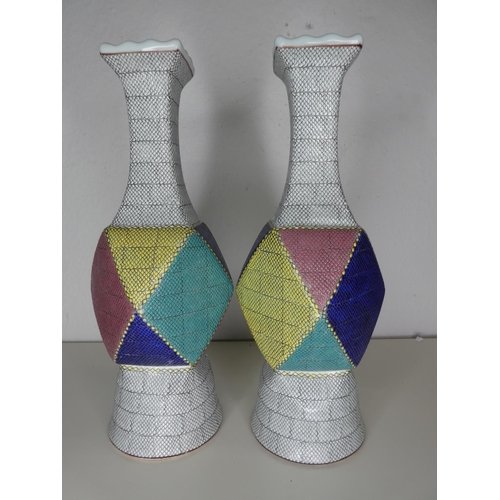 219 - A pair of unusual large ceramic geometrical vases, each signed to base.