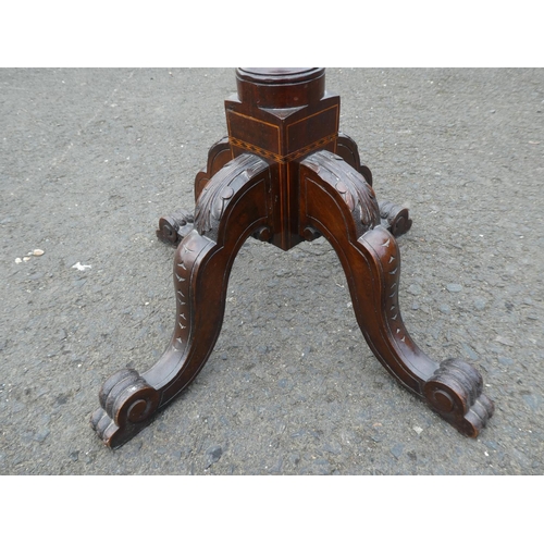 237 - An antique inlaid torchere/ plant stand on tripod base.