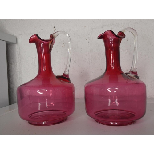 269 - A stunning pair of antique/ Victorian Ruby glass claret jugs.