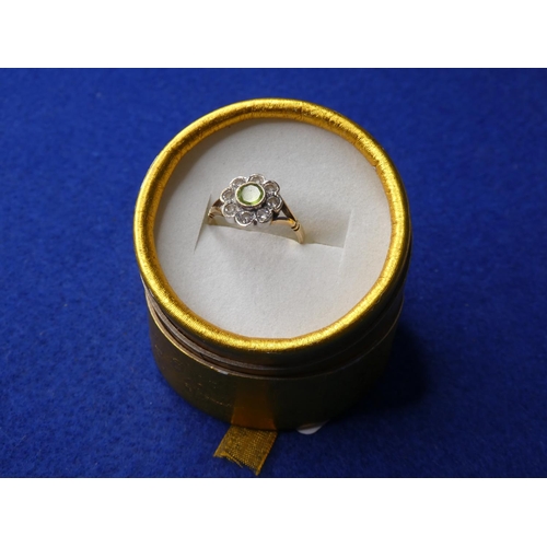 69 - A decorative 9ct gold ring with peridot stone & 8 cubic zirconia.