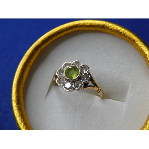 69 - A decorative 9ct gold ring with peridot stone & 8 cubic zirconia.