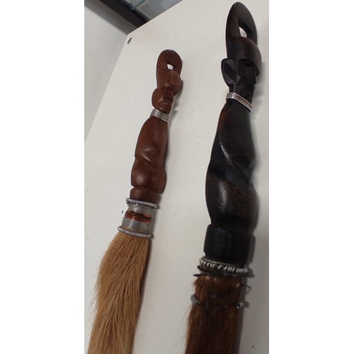 71 - A pair of horsehair tribal brushes with carved handles.