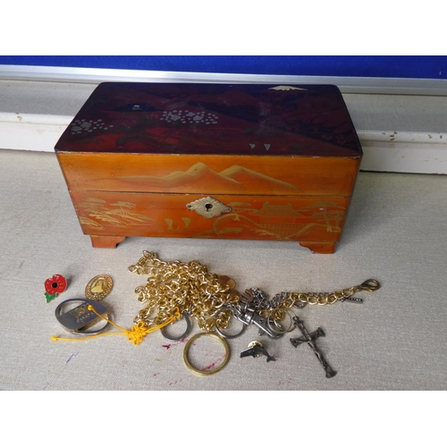 113 - A vintage jewellery box with contents.