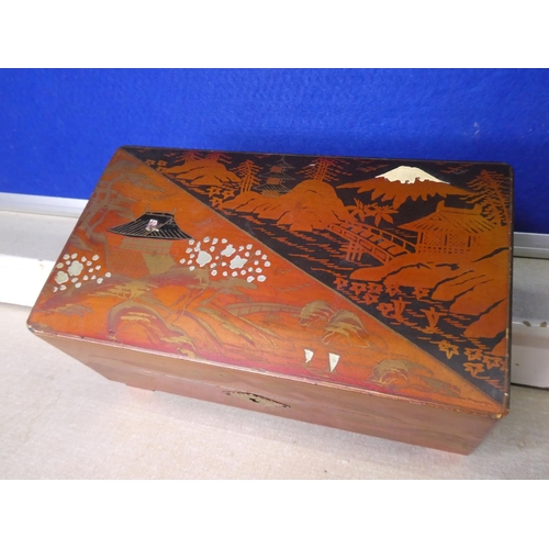 113 - A vintage jewellery box with contents.