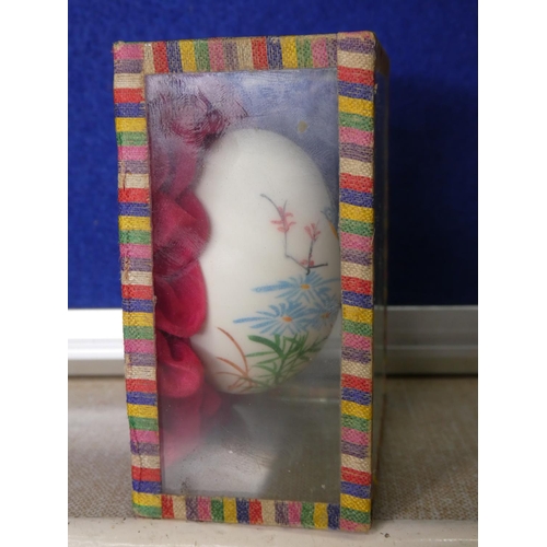 82 - A cased hand painted egg.