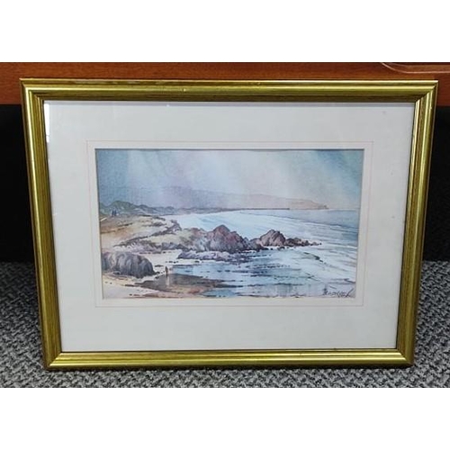 669 - A framed painting of a coastal scene signed by the artist.