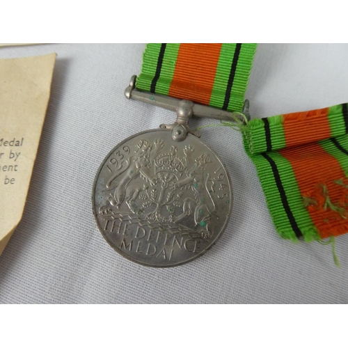103 - A WW2 Defence Medal with paperwork.