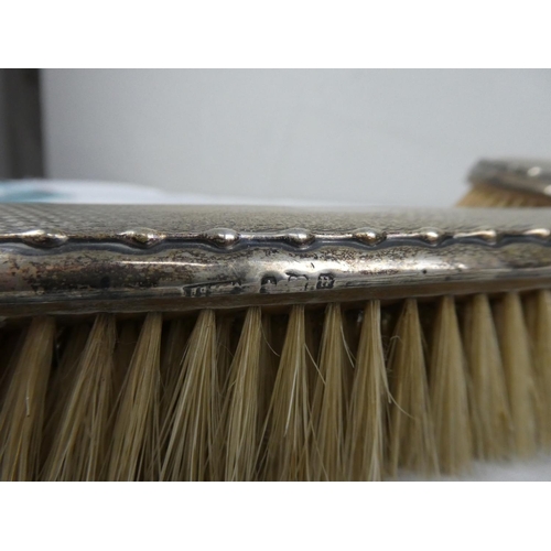 71 - A fully hallmarked set of vanity brushes.
