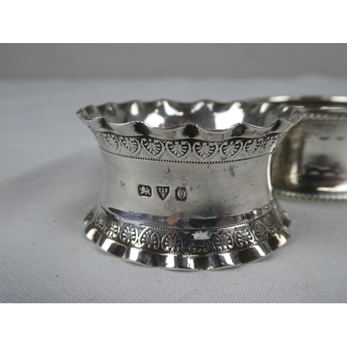 89 - A collection of four Sterling Silver napkin rings.