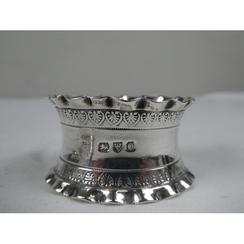 89 - A collection of four Sterling Silver napkin rings.