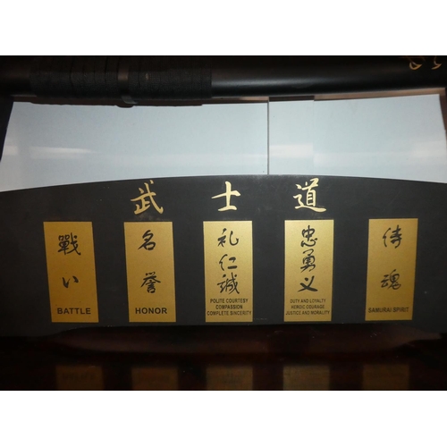 106 - A set of five martial art samurai swords on presentation stand.