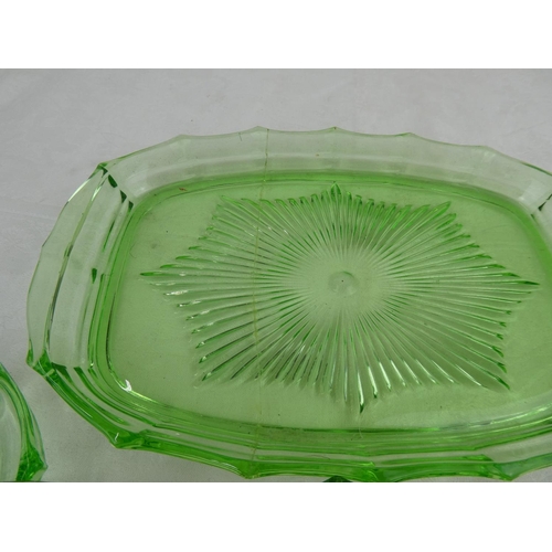 84 - An antique green glass dressing table set.