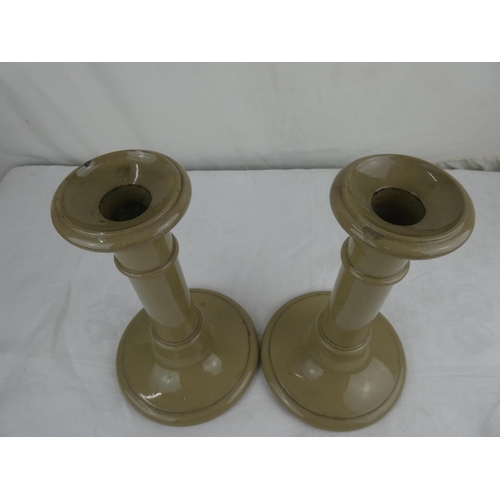 89 - A pair of pottery candlesticks.