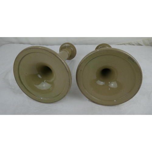 89 - A pair of pottery candlesticks.